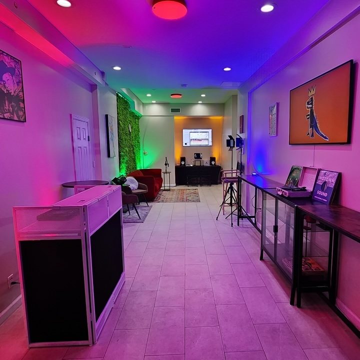 The Hub interior, lit in purple and green, set up for an event