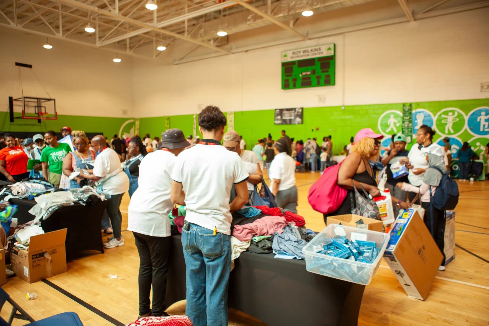Families and volunteers at a Queens Community Closets distribution in a school gym